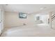 Spacious finished basement featuring neutral carpeting, recessed lighting, and a mounted flatscreen television at 3892 Pelham Rd, Carmel, IN 46074