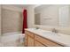 Bathroom with double sinks, tile floor, and shower/tub combo with a red curtain at 3892 Pelham Rd, Carmel, IN 46074