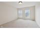 Neutral carpeted bedroom with two bright windows at 3892 Pelham Rd, Carmel, IN 46074