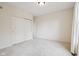 Neutral bedroom with white carpet, white trim, a closet with bi-fold doors, and a single window with white curtains at 3892 Pelham Rd, Carmel, IN 46074