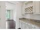 Butler's pantry includes granite counters and custom cabinets, next to dining room at 3892 Pelham Rd, Carmel, IN 46074
