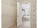Walk-in closet leading to bright bathroom featuring a soaking tub at 3892 Pelham Rd, Carmel, IN 46074