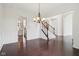 Dining room featuring hardwood floors, wainscoting detail, and a chandelier at 3892 Pelham Rd, Carmel, IN 46074