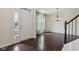 Inviting foyer featuring hardwood floors, stairs, and a bright front door at 3892 Pelham Rd, Carmel, IN 46074