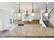 Close-up of the granite kitchen island and countertops with stainless steel appliances at 3892 Pelham Rd, Carmel, IN 46074