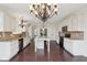 Spacious open-concept kitchen with stainless steel appliances, a center island, and hardwood floors at 3892 Pelham Rd, Carmel, IN 46074