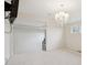 Neutral living room featuring carpet floors, a chandelier, and access to additional rooms of the house at 3892 Pelham Rd, Carmel, IN 46074