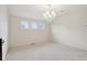 Neutral living room featuring carpet floors, a chandelier, three picture windows and access to other rooms at 3892 Pelham Rd, Carmel, IN 46074
