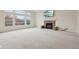 Bright living room featuring a stone fireplace, large windows, and a television at 3892 Pelham Rd, Carmel, IN 46074