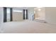 Large living room with neutral walls, carpet, a staircase with black rails, and a pair of picture windows at 3892 Pelham Rd, Carmel, IN 46074