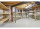 Unfinished storage room with exposed ceiling beams and duct work, along with shelving against the wall at 3892 Pelham Rd, Carmel, IN 46074