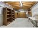 Unfinished storage room features exposed ceiling with shelving and cabinets against the concrete foundation at 3892 Pelham Rd, Carmel, IN 46074
