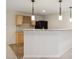 Basement wet bar features light wood cabinetry, granite counters, tile backsplash, wine rack and pendant lighting at 3892 Pelham Rd, Carmel, IN 46074