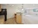 Wet bar featuring light wood cabinets, granite countertops, sink and black refrigerator adjacent to finished basement at 3892 Pelham Rd, Carmel, IN 46074