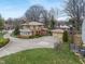 Aerial view of a two-story brick home with mature trees and detached garage at 3901 S Meridian St, Indianapolis, IN 46217
