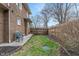 Private, partially fenced backyard space showcasing the home's exterior and a grassy area at 3901 S Meridian St, Indianapolis, IN 46217