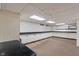 Unfinished basement provides ample storage space with white cabinets along the walls at 3901 S Meridian St, Indianapolis, IN 46217