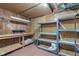 Unfinished basement featuring workbench, shelving, and ample storage space at 3901 S Meridian St, Indianapolis, IN 46217