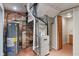 Basement utility area with water heater and furnace featuring brick accent wall at 3901 S Meridian St, Indianapolis, IN 46217