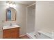 Simple bathroom featuring a vanity sink, toilet, and shower with vinyl stall at 3901 S Meridian St, Indianapolis, IN 46217