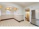 Bright dining area with tiled walls, stainless steel refrigerator, and stairs leading to the entry at 3901 S Meridian St, Indianapolis, IN 46217