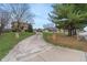 Long concrete driveway leading up to a beautiful home with a landscaped yard at 3901 S Meridian St, Indianapolis, IN 46217