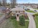 Aerial view of a two-story brick home with manicured lawn and long driveway at 3901 S Meridian St, Indianapolis, IN 46217