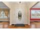 Inviting foyer features hardwood floors, a decorative front door, and elegant chandelier at 3901 S Meridian St, Indianapolis, IN 46217
