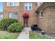 Charming brick home featuring mature landscaping, a decorative door and red awning at 3901 S Meridian St, Indianapolis, IN 46217