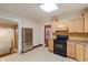 Well-lit kitchen featuring stainless steel refrigerator, tile floors, and ample cabinet space at 3901 S Meridian St, Indianapolis, IN 46217