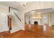 Charming living room features hardwood floors, a staircase, and a view to another room at 3901 S Meridian St, Indianapolis, IN 46217