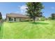 Spacious backyard with lush green grass, mature tree, and a full fence at 4043 Oak Trail Dr, Indianapolis, IN 46237