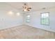 Spacious bedroom featuring neutral carpet, a ceiling fan, and two windows with natural light at 4043 Oak Trail Dr, Indianapolis, IN 46237