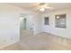 Bright bedroom with a ceiling fan, neutral carpet, and open doorway at 4043 Oak Trail Dr, Indianapolis, IN 46237