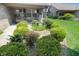Landscaped front yard with lush greenery, flowers, and a small bird bath, leading to the home's entrance at 4043 Oak Trail Dr, Indianapolis, IN 46237