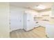 Clean, all-white kitchen with modern appliances and wood-look flooring at 4043 Oak Trail Dr, Indianapolis, IN 46237