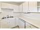 Close-up of the kitchen showcasing white cabinetry, countertops, and stainless steel sink at 4043 Oak Trail Dr, Indianapolis, IN 46237