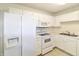 Well-maintained kitchen featuring white cabinets, appliances, and a functional layout at 4043 Oak Trail Dr, Indianapolis, IN 46237