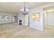 Spacious living room with a decorative chandelier, fireplace, and view into the adjacent kitchen at 4043 Oak Trail Dr, Indianapolis, IN 46237