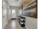 The bright entryway includes durable flooring, a console table, artwork, and interior doors at 4535 Laughter Ln, Indianapolis, IN 46235