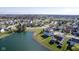 Community homes near a pond, showcasing mature trees, well-manicured lawns, and a tranquil environment at 4801 Copper Grove Dr, Indianapolis, IN 46237