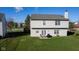 Well-maintained backyard with green grass, a patio, chairs, and a grill, perfect for outdoor enjoyment at 4801 Copper Grove Dr, Indianapolis, IN 46237