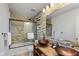 Bathroom with stylish vessel sinks, a stone accent wall, and a glass enclosed shower at 4801 Copper Grove Dr, Indianapolis, IN 46237