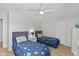 Bedroom featuring two twin beds, neutral walls, and a ceiling fan at 4801 Copper Grove Dr, Indianapolis, IN 46237