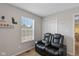 Cozy bedroom with a modern leather recliner, natural light from the window, and unique decorative shelves at 4801 Copper Grove Dr, Indianapolis, IN 46237