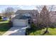 Two-story home with manicured lawn, mature tree, brick facade, and an attached two-car garage at 4801 Copper Grove Dr, Indianapolis, IN 46237