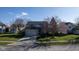 Charming two-story home with well-manicured lawn, mature trees, and a brick facade with attached two car garage at 4801 Copper Grove Dr, Indianapolis, IN 46237