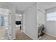 Hallway featuring a laundry area and an open doorway leading to another room at 4801 Copper Grove Dr, Indianapolis, IN 46237