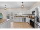 Bright kitchen with white cabinets, stainless steel appliances, and a view of the backyard at 4801 Copper Grove Dr, Indianapolis, IN 46237
