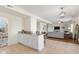 Open-concept kitchen featuring a breakfast bar, tile floors, and seamless access to the living area at 4801 Copper Grove Dr, Indianapolis, IN 46237